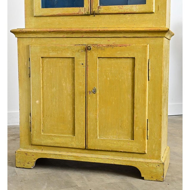 This tall and narrow English bookcase is perfect for a slender wall needing storage and display. The recently painted...