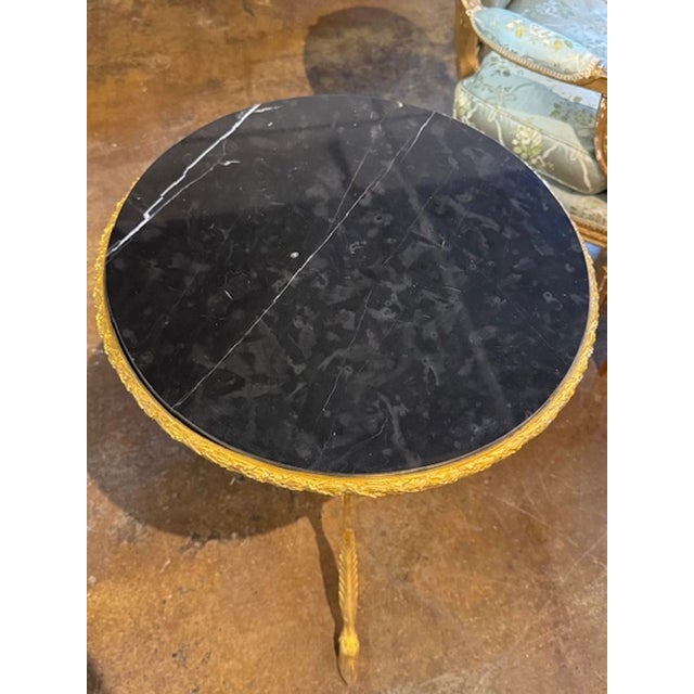 This product is a stylish and elegant 19th century Louis XVI bronze and black marble side table. The table features a...