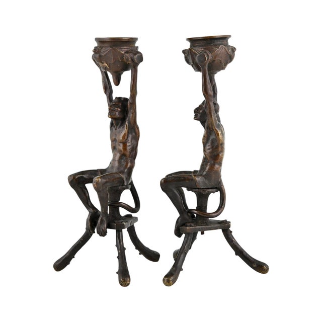 Antique bronze Mephisto candlesticks in the Gothic Revival style, dating from circa 1880. The Mephisto figures are seated...