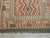 vintage handwoven kilim features a bold tribal design with four stacked diamond medallions framed by rhythmic geometric...