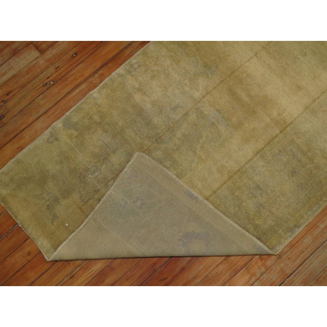 Pale yellow gold vintage Turkish Oushak from the mid-20th century. Measures: 2'7” x 9'11”.