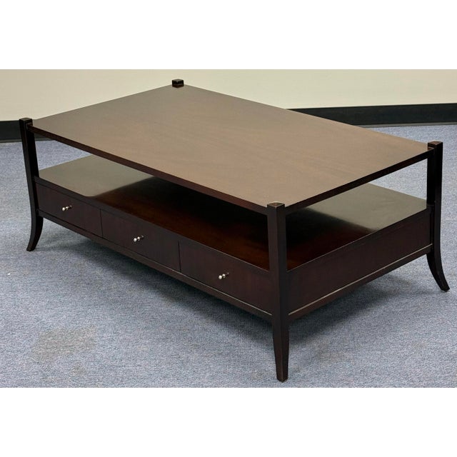 Chic dark wood coffee table Coffee Table by Baker Furniture, designed by Barbara Barry.Features a rich java finish and...