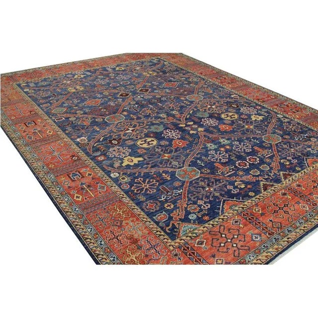 ACTUAL SIZE: 9’1″ x 11’10” PRIMARY COLOR: Navy, Rust AGE: New ORIGIN: Pakistan MATERIALS: Wool FOUNDATION: Cotton...