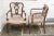A coordinating pair of intricately carved vintage Regency style armchairs with finely crafted needlepoint seat cushions...