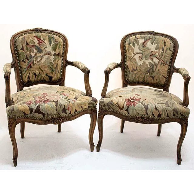 Pair of French Regency style arm chairs with vintage/antique tapestry upholstery. Regarding condition, one chair shows...