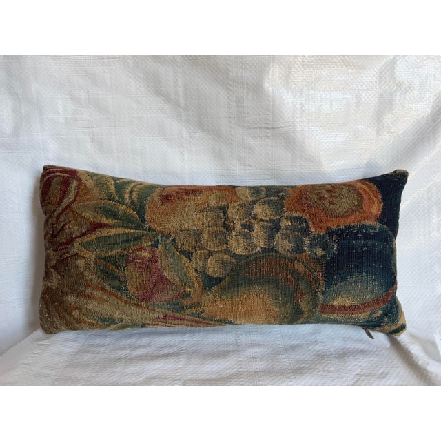 This exceptional antique pillow is fashioned from a 17th-century Flemish tapestry fragment, featuring a richly composed...