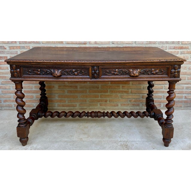 Impressive French writing table dating from the 20th century, crafted in wood and richly decorated with carved floral and...