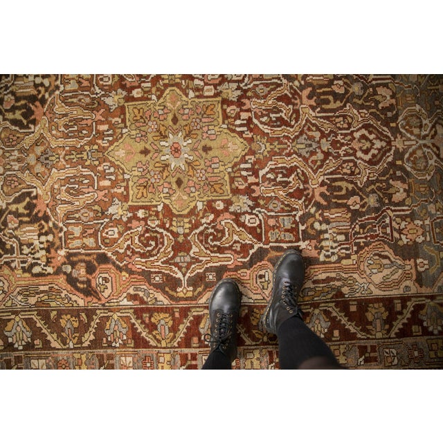 :: Oversized center medallion defined by scrolled arabesques and blossoms with interior concentric minor medallion in...