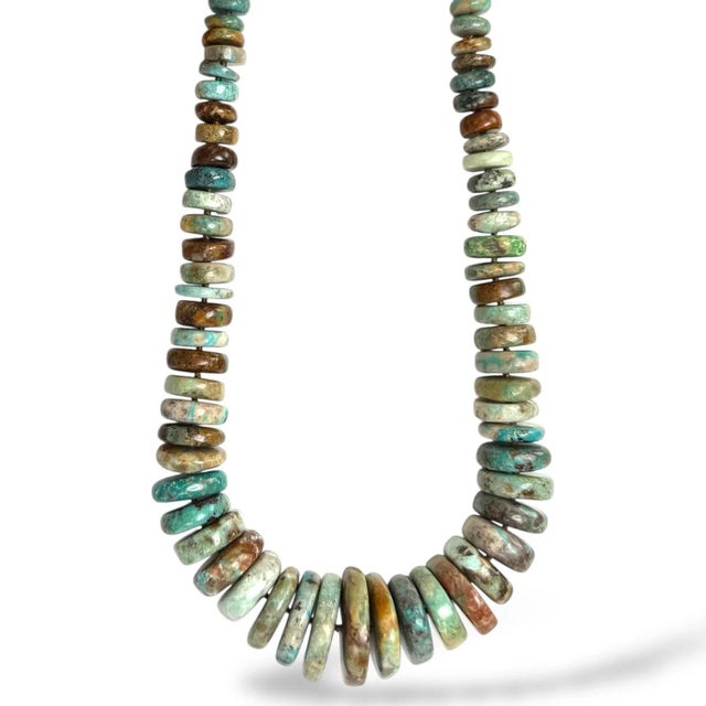 Earthy hues by way of natural Turquoise cut into this unique disc silhouette. Length is 19-21