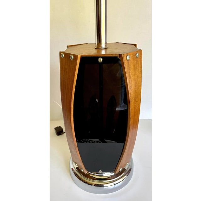 Here is a fantastic mid-century, space-age, modern table lamp featuring curved pieces of teak wood over smoky gray lucite...