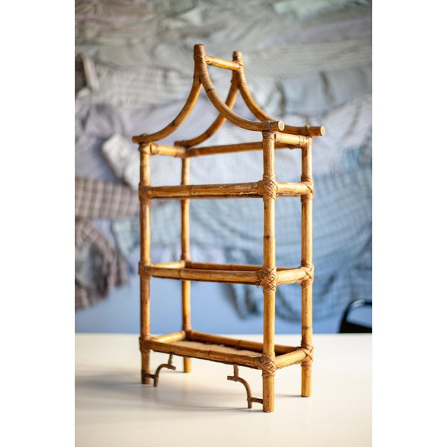 Bamboo structure with rush bindings and shelves covered in rush fabric.
