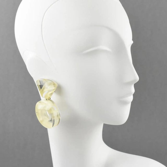 Harriet Bauknight for Kaso designed these stunning lucite or acrylic clip-on earrings. The giant donut's dangling shape,...