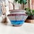 Elevate your home decor with the Artisan Signed Wheel Thrown Pottery Colorful Vase by Trina Reyes, crafted in 1984. This...
