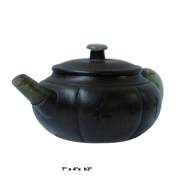 This is a Zisha teapot with Chinese characters motif surface and jade stone material handle and mouth. Not for beverage...