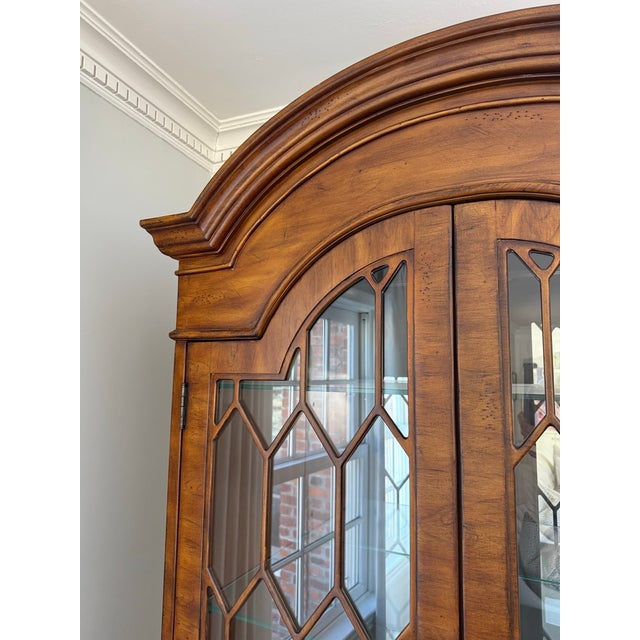High quality traditional curio cabinet. Glass doors with wood accents. Four adjustable glass shelves and mirrored back....