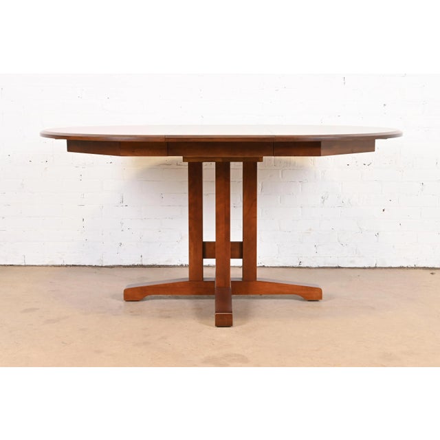 A gorgeous Mission, Arts & Crafts, or Shaker style solid cherry wood pedestal extension dining table In the manner of...
