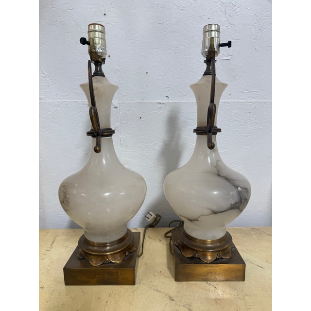 A pair of grey and white alabaster marble in a baluster form bronze mounted. The alabaster is natural, so both pairs are...