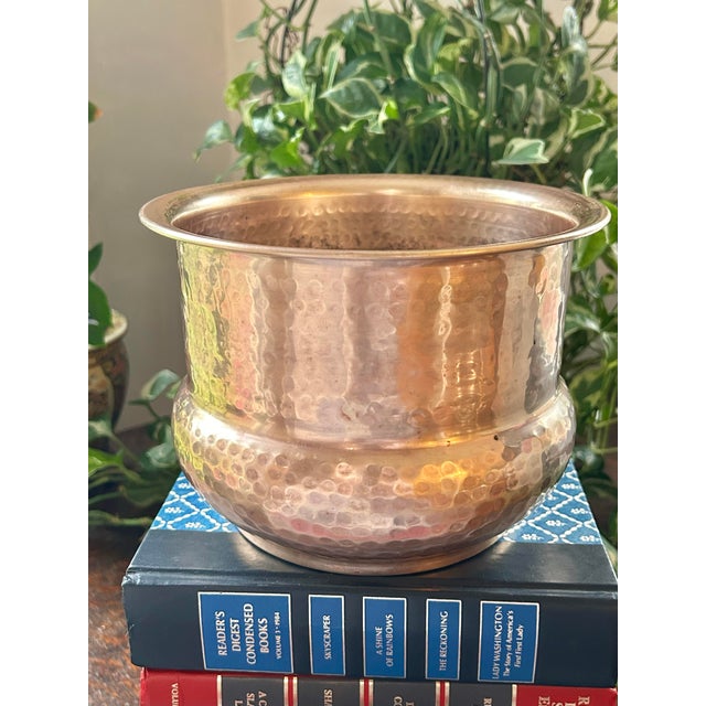 Perfect for holding an orchid or green plant, this hammered brass cache pot or indoor planter hails from the late 20th...