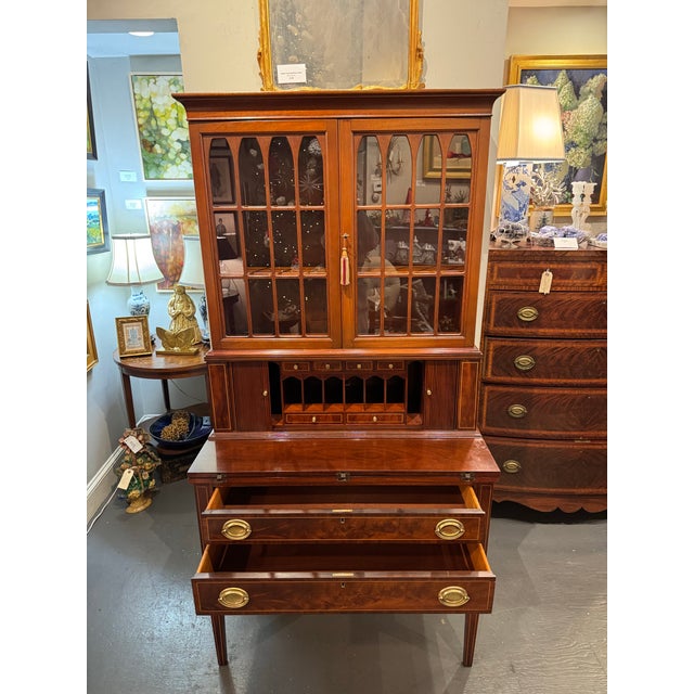 This is a vintage mahogany with inlay tambour Secretary. It has two large drawers, and six small drawers for storage. The...