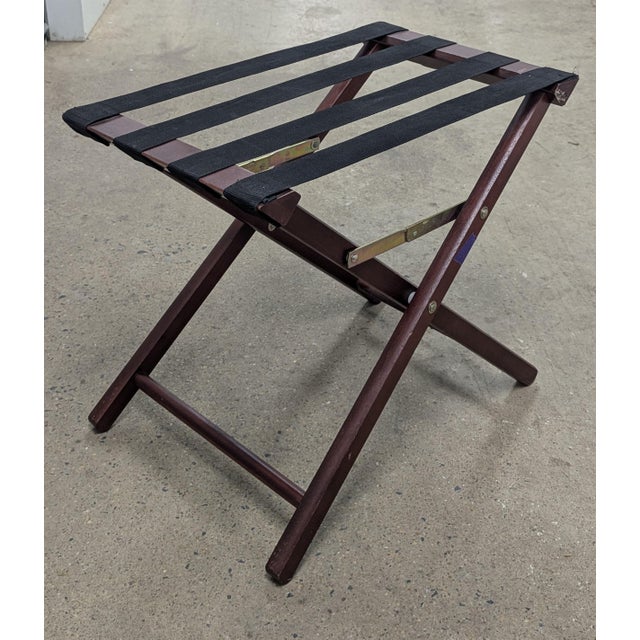 Elevate your guest suite with this timeless vintage folding luggage rack. Crafted from sturdy wood and accented with...