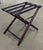 Elevate your guest suite with this timeless vintage folding luggage rack. Crafted from sturdy wood and accented with...