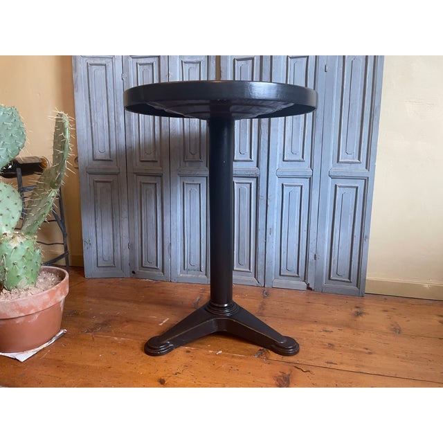 A Tolix bistro table from France. Beautiful round model with an iron base and a metal top. Dating from around the...