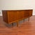 Vintage mid-century long teak sideboard bar made in the U.K. by Jentique circa 1960's. This piece features beautiful...