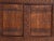 This antique carved sideboard in pine wood is a Uyghur cabinet from Xinjiang with four carved doors and a lobed-arch...