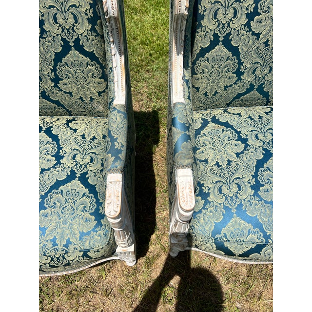 Elegant pair of 19th-century French Louis XVI bergère armchairs, crafted in carved painted walnut with fluted legs and...