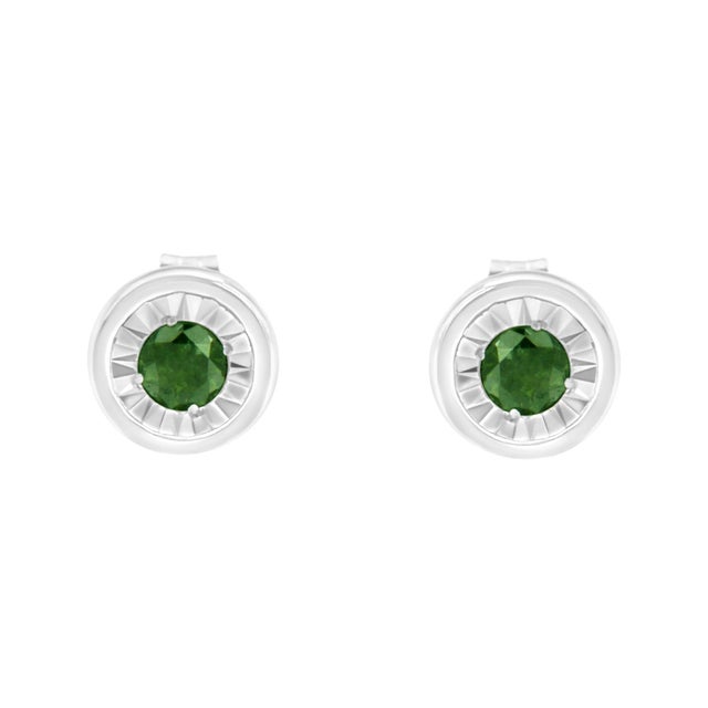 This modern pair of diamond studs features color treated green diamonds in a bezel setting. The sleek design is crafted in...