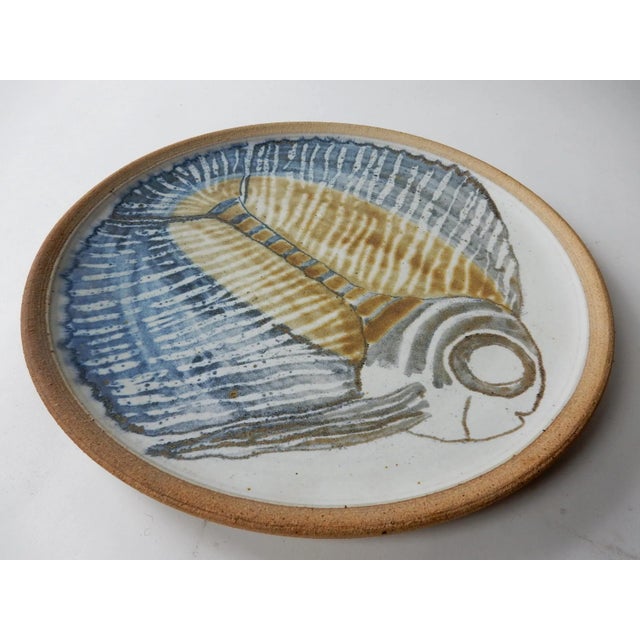 Large art pottery fish charger or platter signed "ROWE". 15.75in wide. Stoneware with glaze fish design. It's fabulous! It...
