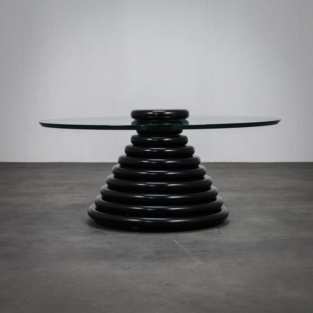 A rare Italian postmodern coffee table dating to the 1980s, defined by its bold sculptural base and restrained geometric...