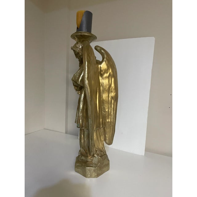 Stunning gilded angel candle holder. The intricate details of the guardian angel create a serene and peaceful ambiance,...