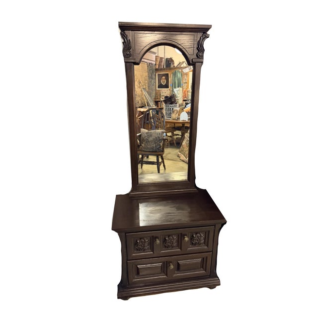 Substantial vintage dark-stained wood bedroom set featuring a long dresser and matching two-drawer mirror chest, with...