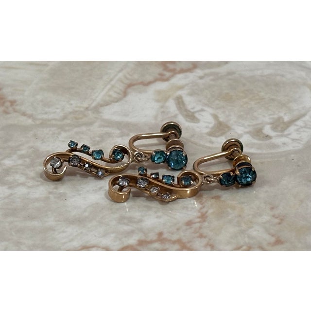 1940s-50s 12k gold filled/plated screw-back dangle/drop earrings w/ teal blue rhinestones. Marked at back of screw closure.