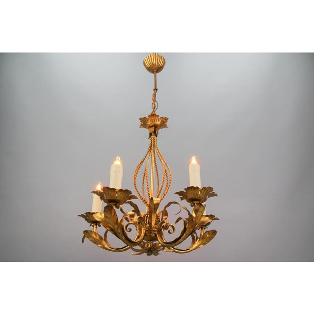 - Italian Hollywood Regency style gilt metal five-light chandelier, circa the 1970s - A beautiful Italian gilt...