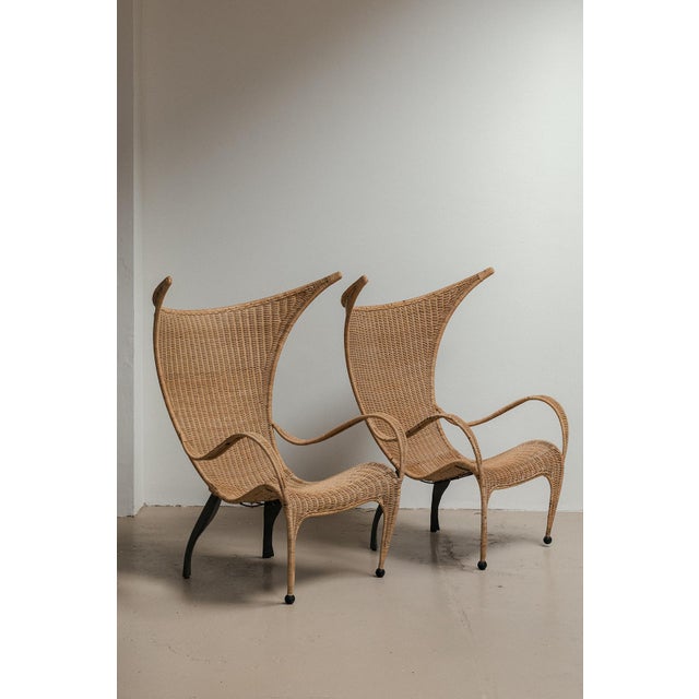 Sculptural easy chairs produced in Italy around 1980. Pompous design with a steel frame and finished with a wicker seat....