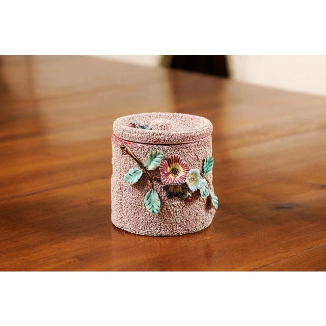 An English pottery box from the 20th century, with floral motifs, textured ground and lid. Created in England during the...