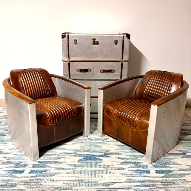 Pair of chairs only, other items included for staging purposes only but are for sale separately. Striking pair of aviator-...