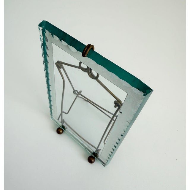 Antique French circa 1920s easel-style picture frame with a folding brass frame that holds a thick glass panel. The edge...