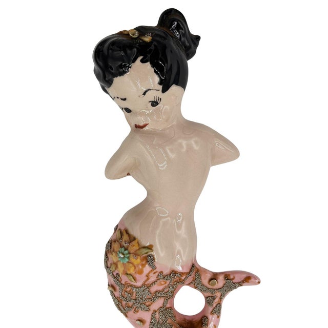 Original Mid-century ceramic wall sculpture featuring a classic pin-up-inspired design features a brunette hair tied back...