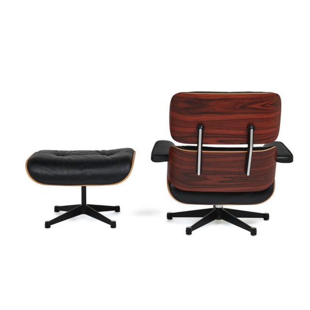 Armchair model 670 “Lounge Chair” and ottoman model 671 — designs created in 1956. Base in black lacquered steel,...