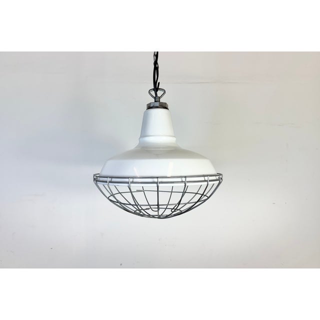 Industrial white enamel factory pendant light made by Benjamin in United States during the 1960s. White enamel inside the...