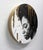 This artwork features a striking profile of a woman, rendered in charcoal and pastel, which captures a moment of...
