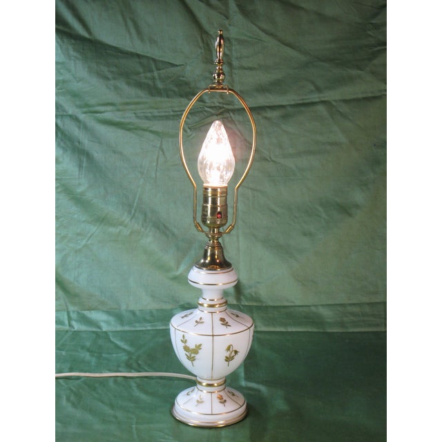 This product is a stunning table lamp featuring frosted glass with gold flowers and brass details, embodying the Hollywood...