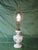This product is a stunning table lamp featuring frosted glass with gold flowers and brass details, embodying the Hollywood...