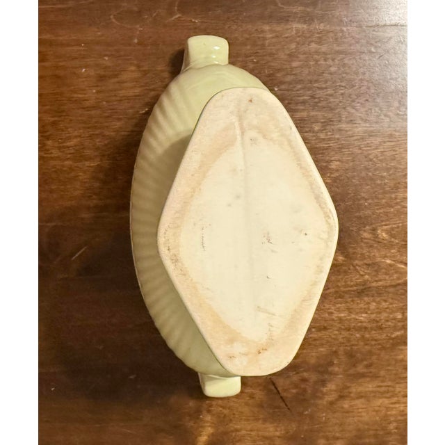 This is a vintage ceramic compote bowl, from the 1950s, characterized by its distinctive chartreuse (light yellowish-...