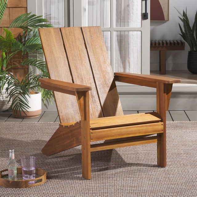 Elevate your outdoor relaxation with the Alton Adirondack chair in teak. Crafted from robust wood, this chair combines...