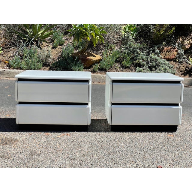 Rare 1980s white lacquered nightstands with contrasting ribbed black rubber accents by Roger Rougier. Beautiful ultra...