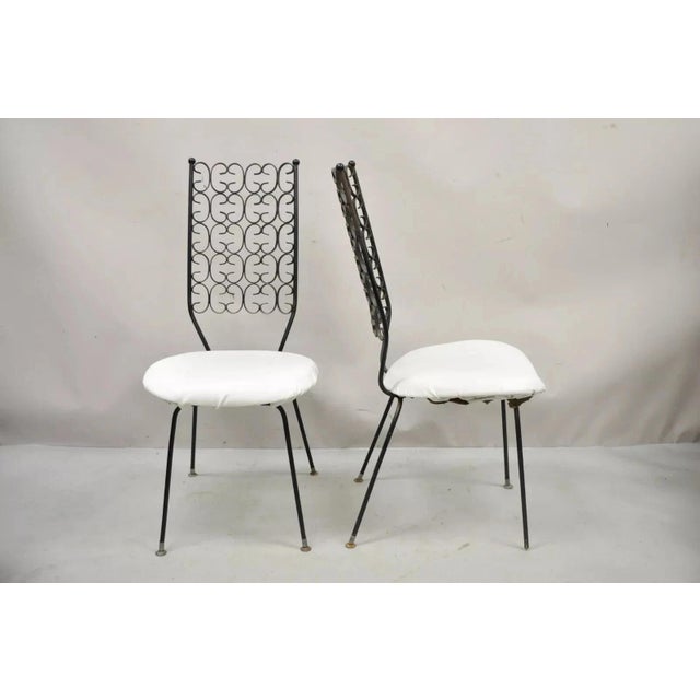Vintage Mid century Modern Salterini Umanoff Style Wrought Iron Scroll Dining Side Chairs - a Pair. Item features a...